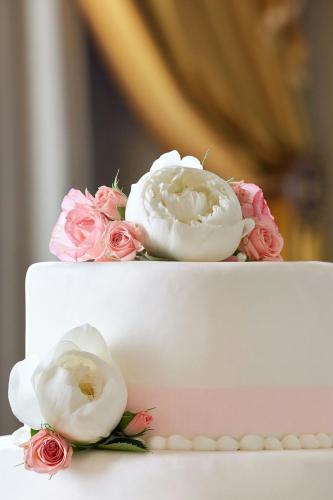 a white and pink cake with flowers on it at Hotel Grande Bretagne, a Luxury Collection Hotel, Athens in Athens