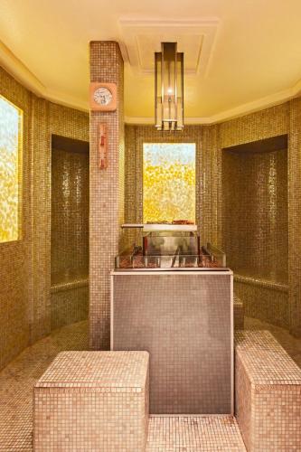 a bathroom with two stools and a clock on the wall at Hotel Grande Bretagne, a Luxury Collection Hotel, Athens in Athens