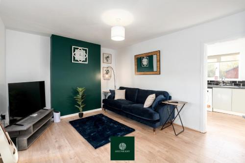 a living room with a couch and a tv at 3 Bed House with King Size bed near Uni and QMC in Nottingham