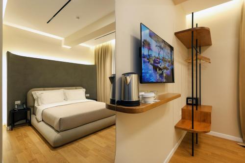 a hotel room with a bed and a picture on the wall at Beratinus1 in Berat