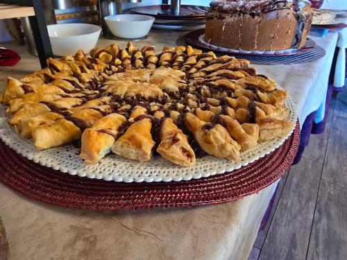 a large cake on a table with a chocolate cake at Hotel del Lago Ampollino in Torre Caprara