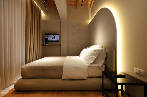 a bedroom with a bed with an arched window at Beratinus1 in Berat