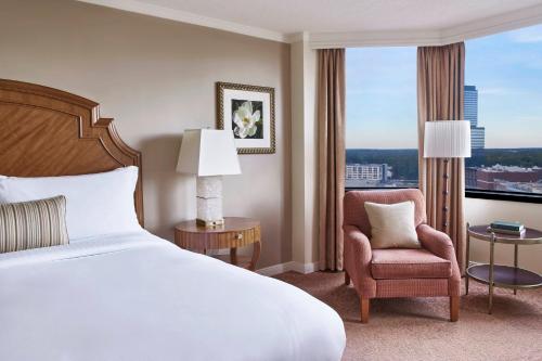 a hotel room with a bed and a chair and a window at The Whitley, a Luxury Collection Hotel, Atlanta Buckhead in Atlanta
