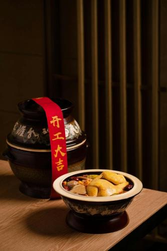 a bowl of food on a table with a red ribbon at Chengdu Marriott Hotel Financial Centre in Chengdu