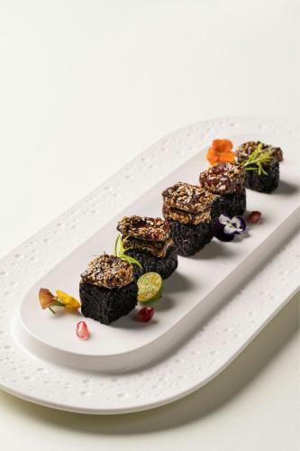 a plate of black food on a white plate at Chengdu Marriott Hotel Financial Centre in Chengdu