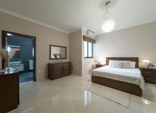 a large bedroom with a bed and a bathroom at Jacuzzi Terrace Getaway with Valletta Views in Sliema