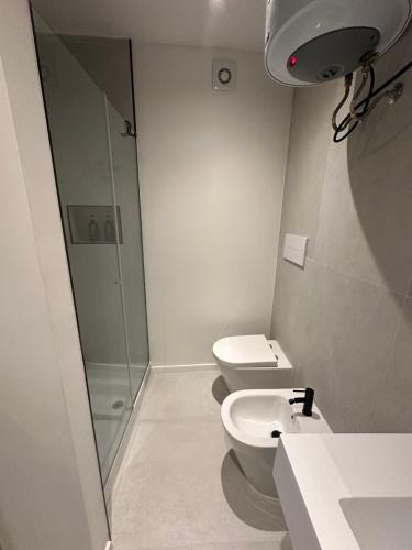 a bathroom with a shower and a toilet and a sink at Le Quattro Chiavi in Palermo