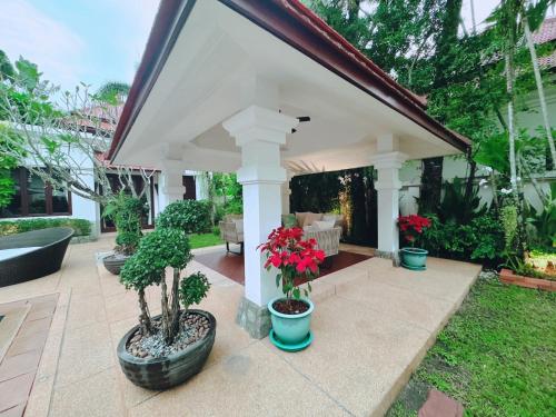 a pavilion with potted plants on a patio at Saitaan Villa Dennapa Bang Tao Beach in Bang Tao Beach