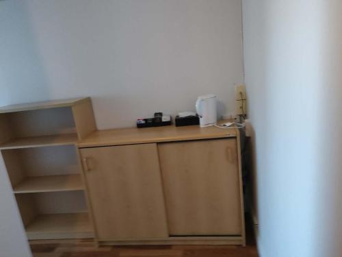 a small kitchen with a counter and a refrigerator at 5 Beds including 1 Double Bed, 2 single Beds, 2 Double Sofa Beds, Suite 4, 37 Totara Avenue, New Lynn in Auckland