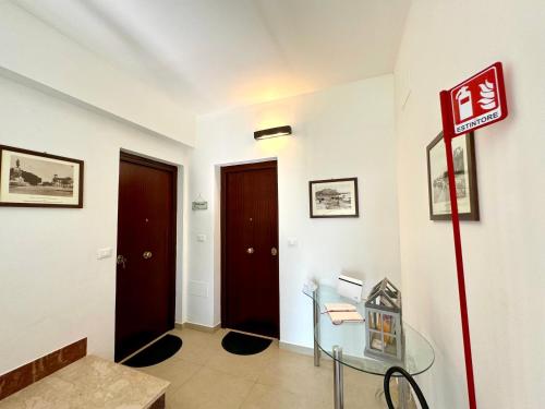 a room with a glass table and a door at Casa di Mami in Capaci