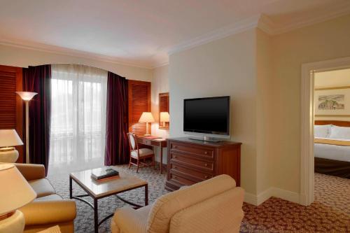 a hotel room with a television and a living room at Sheraton Addis, a Luxury Collection Hotel, Addis Ababa in Addis Ababa