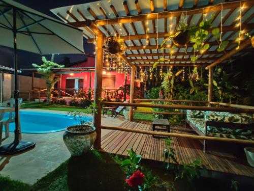 a patio with a pergola and a swimming pool at Casa alto da vista in Tibau do Sul