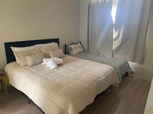 a bed with two stuffed animals on top of it at Pousada Le Sorelle apt03 in Rosário do Sul