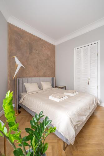 a bedroom with a large bed in a room at Luxury Design 2BR Apartment cozy stay for 5 in Riga