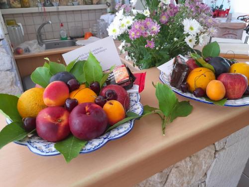 two plates of fruit on top of a counter at Calergi Residence - Holidays in Crete in Atsipopoulo