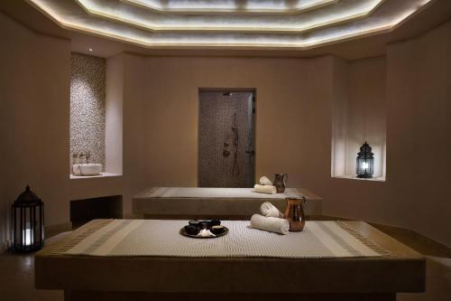 a bathroom with a bath tub and a sink at Al Wathba, a Luxury Collection Desert Resort & Spa, Abu Dhabi in Abu Dhabi