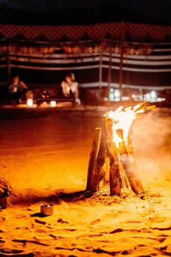 a fire show in a stage with people in the background at Al Wathba, a Luxury Collection Desert Resort & Spa, Abu Dhabi in Abu Dhabi