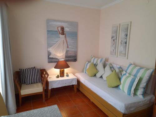 a living room with a couch and a painting on the wall at Calergi Residence - Holidays in Crete in Atsipopoulo