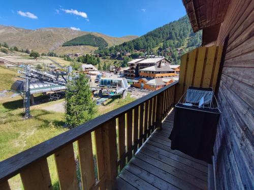 a balcony of a cabin with a view of the mountains at Duplex 6 personne au pied des pistes in Allos