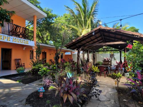 a patio at a house with a bunch of plants at Ometepe House in Moyogalpa