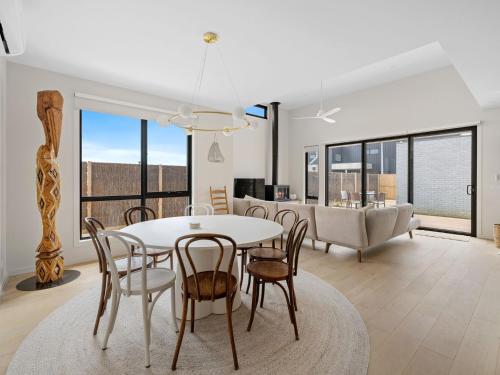 a dining room and living room with a table and chairs at Wirilda Retreat in Inverloch