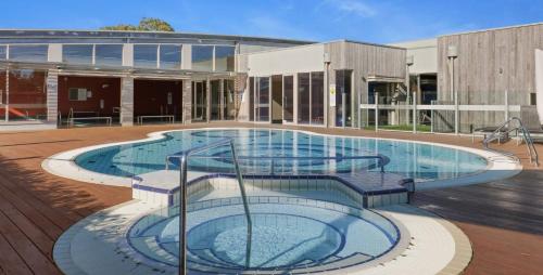 a large swimming pool in front of a building at Wirilda Retreat in Inverloch