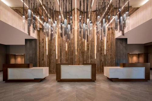 a lobby with a large chandelier in a building at Denver Marriott Tech Center in Greenwood Village
