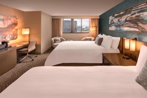 a hotel room with two beds and a desk at Denver Marriott Tech Center in Greenwood Village