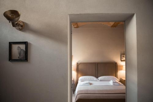 a bedroom with a large bed and a mirror at Le Antiche Mura 2 in Guastalla