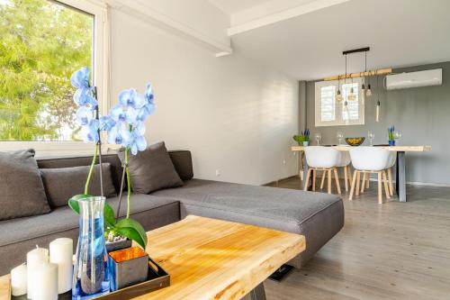 a living room with a couch and a table at Eclipse Vouliagmeni Center in Athens