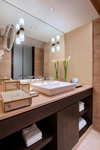 a bathroom with a large sink and a large mirror at JW Marriott El Convento Cusco in Cusco