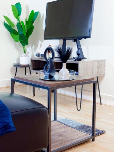 a desk with a computer monitor on top of it at Glasgow City Centre Stylish Flat in Glasgow