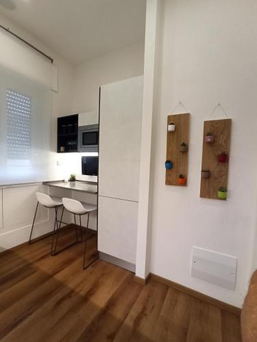 a kitchen with a white wall with twoabinets on it at Carneval and Tuscany in Viareggio