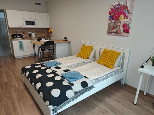 a bedroom with a bed with polka dot pillows at Comfort flat with great location in Prague
