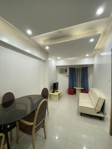 a living room with a couch and a table at Roxas Blvd Stunning Studio Condo Near US Embassy in Manila