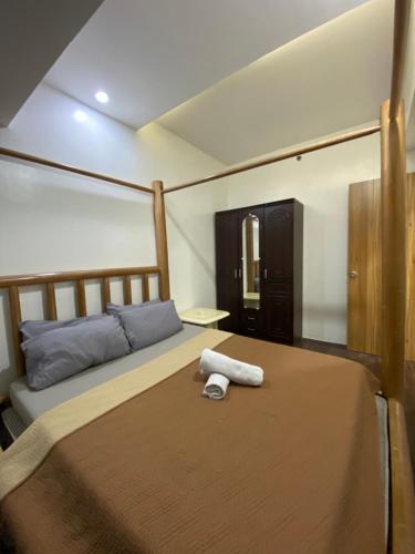 a bedroom with a bed with a towel on it at Roxas Blvd Stunning Studio Condo Near US Embassy in Manila