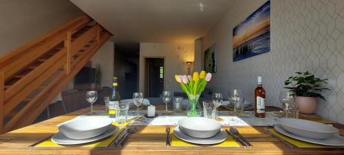 a dining room table with plates and dishes on it at Wellness apartmány Říčky v Orlických horách in Říčky