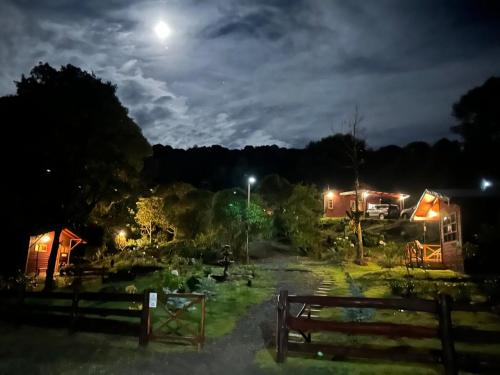 a field at night with the moon in the sky at Curuba Lodge in El Copey