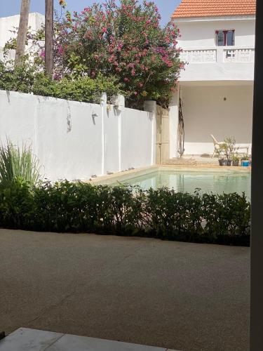 a swimming pool in front of a house at Zion in Ngaparou