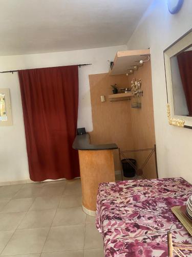 a bedroom with a bed and a red curtain at Zion in Ngaparou