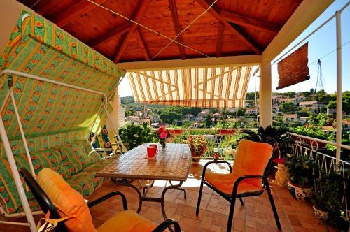 a patio with a table and chairs on a balcony at Apartments Kat in Splitska