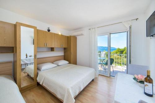 Ένα ή περισσότερα κρεβάτια σε δωμάτιο στο Apartments Gloria