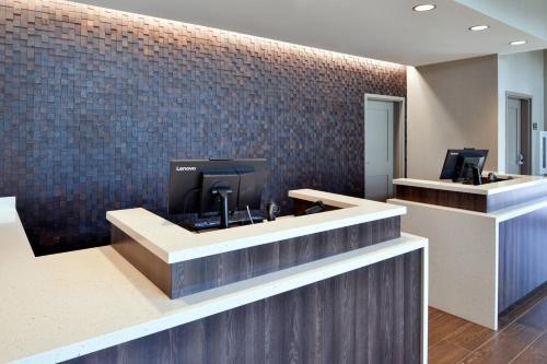 an office lobby with a counter and a tile wall at Residence Inn by Marriott Bakersfield West in Bakersfield