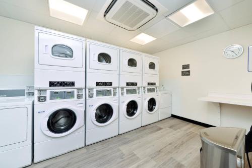 a laundry room with four washer and dryers at Residence Inn by Marriott Bakersfield West in Bakersfield