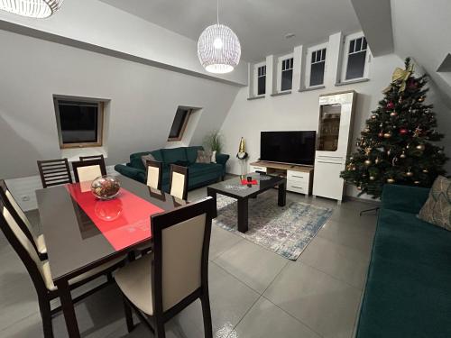 a living room with a christmas tree and a table at WILLA DobraNocka in Szklarska Poręba