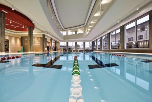 a large swimming pool in a building at Hotel Villa Glicini in Pinerolo
