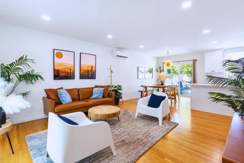 a living room with a couch and a table at Spacious 3BR Home Near Disneyland & Knotts Berry Farm in Fullerton