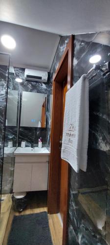 a bathroom with a sink and a mirror and a towel at Vila MINA LUX in Kaludjerske Bare