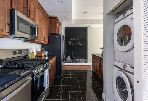 a kitchen with a stove and a washer and dryer at Luxury 3BR with Parking in Heart of DC - Steps to Metro in Washington