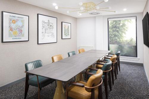 a conference room with a long table and chairs at Four Points by Sheraton Edinburgh in Edinburgh